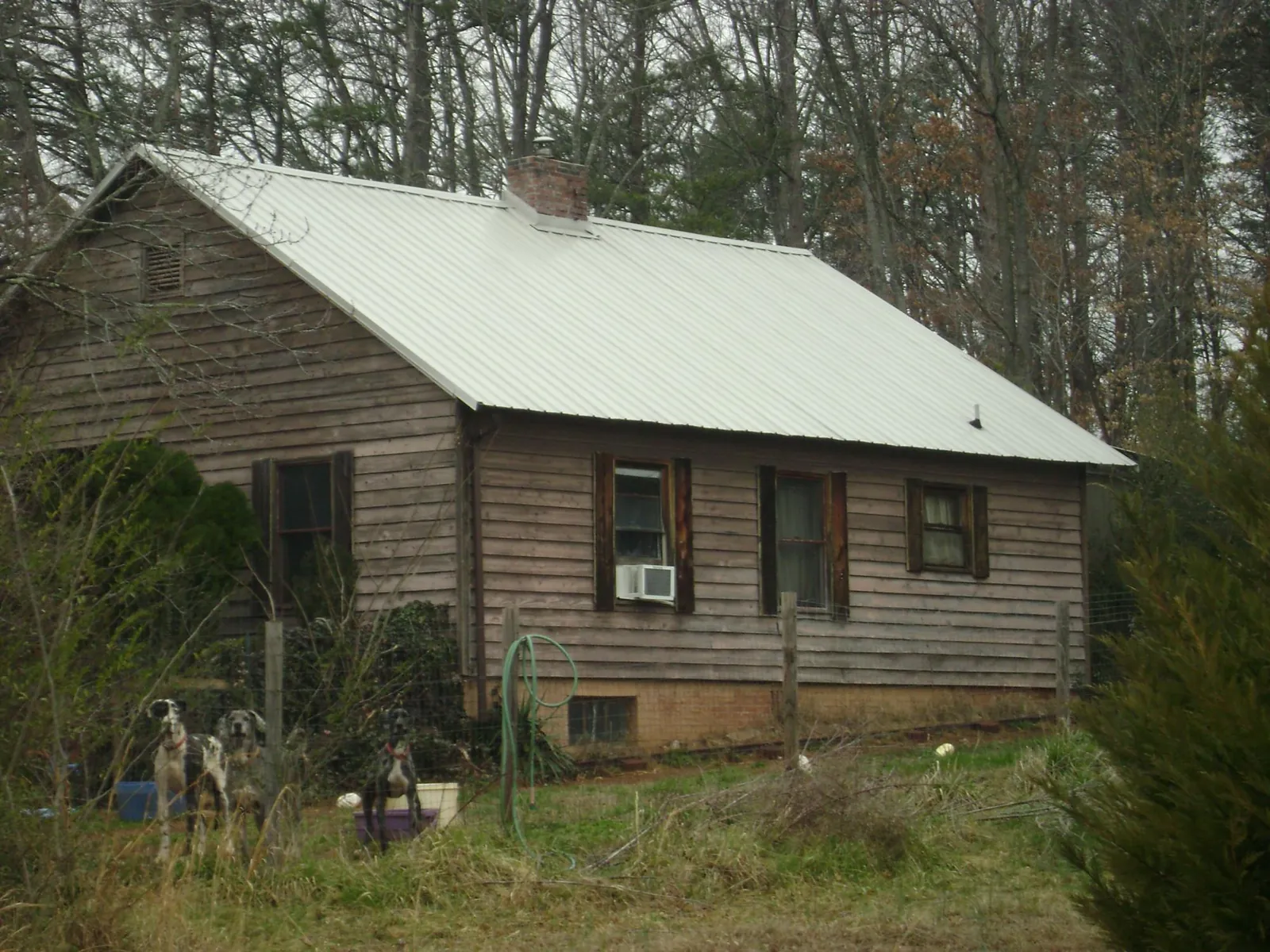 White metal roof on an old wood sided farmhouse, from a Metal Roof Installation job in Willseyville